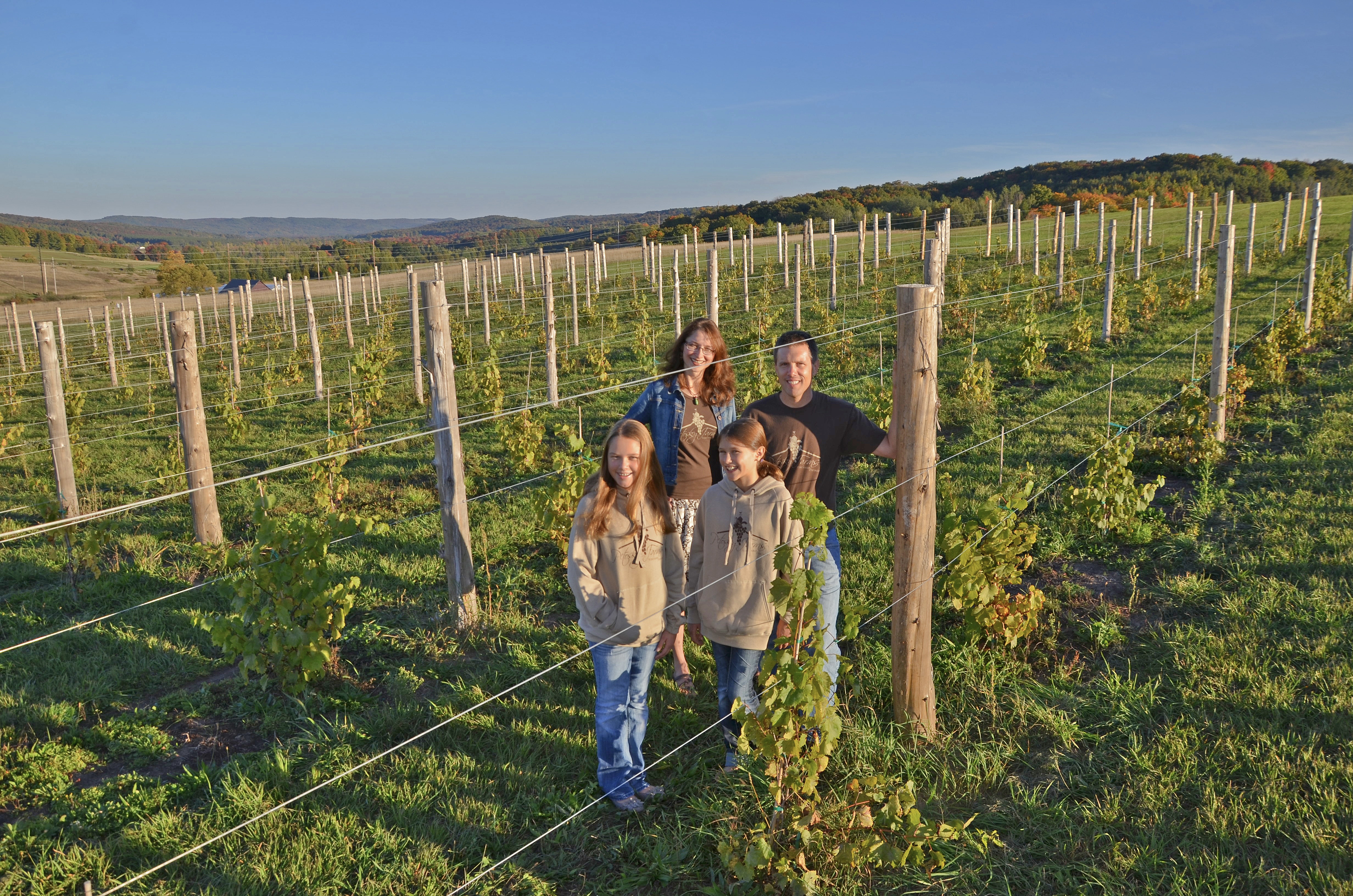 The Roush family standing in their vineyard.